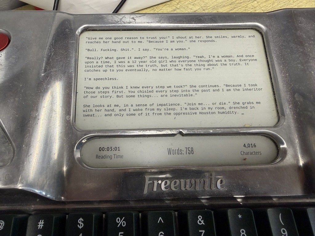 A photo of my Hemingwrite being used at work to write my first novel.