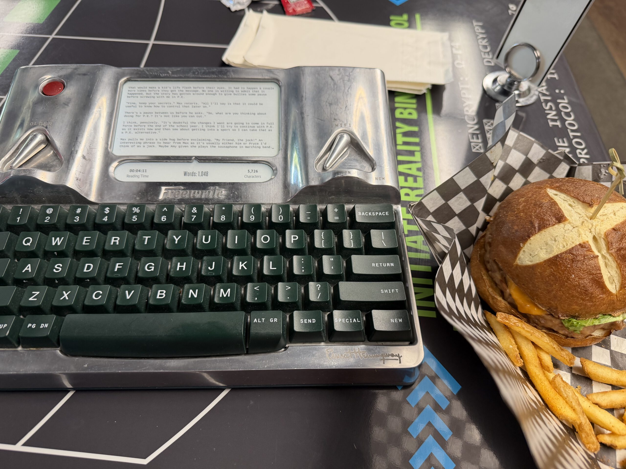 A burger and fries right next to my Hemingwrite